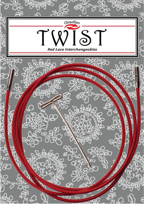 Red interchangeable knitting needles on a floral patterned background with a label above.