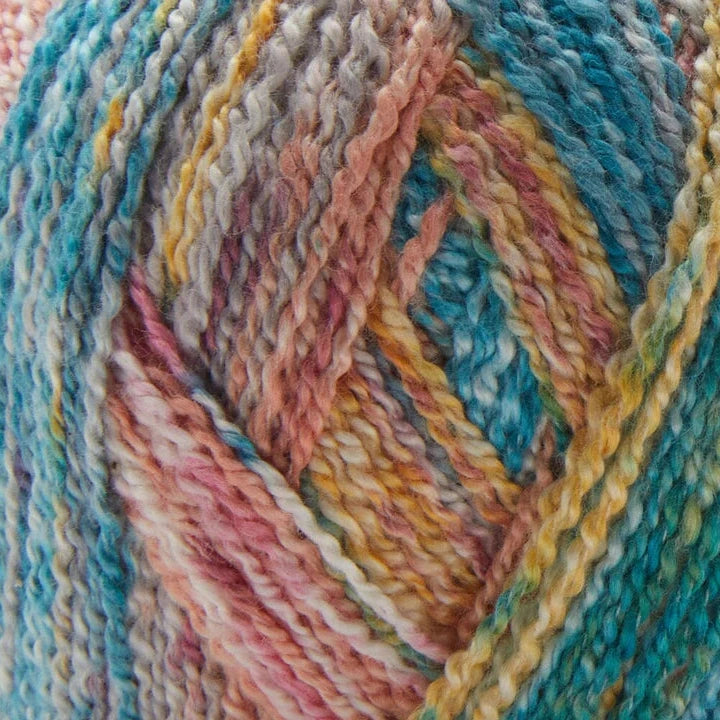 Close-up of multicolored yarn and knitted fabric with a pattern.