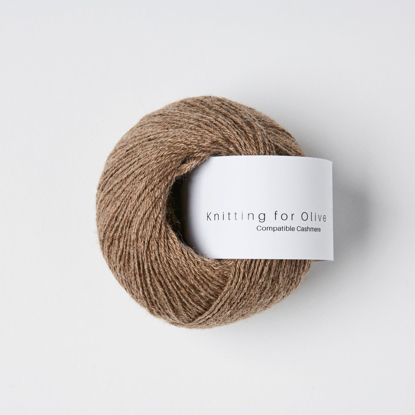 Ball of yarn with a 'Knitting for Olive' label on a white background