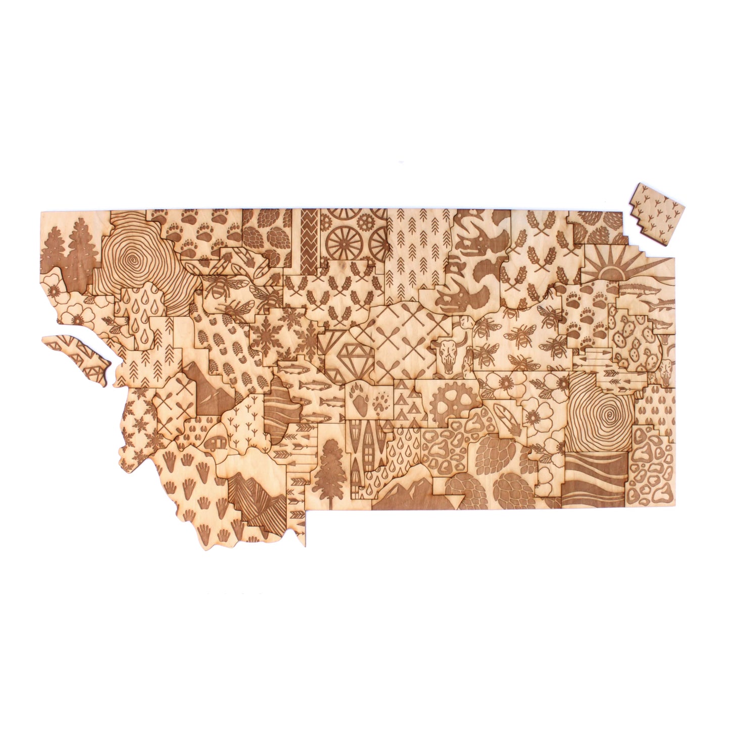 Wooden cutout in the shape of the state of Montana with various patterns on a white background