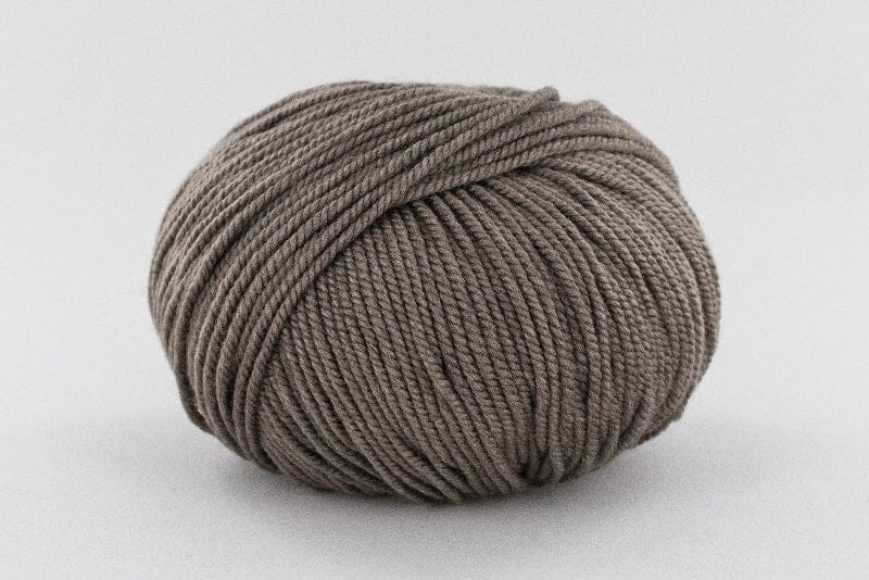 Ball of brown yarn on a light gray background