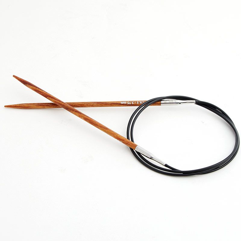 Wooden knitting needles with a black cable on a white background